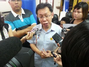 Dr. Sim talks to the press.