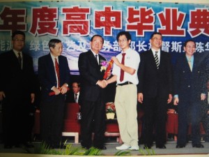 Tan Sri Peter Chin giving a cert to a student, Jethro. Second right is Richard Wee