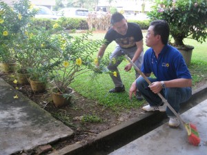 Lai Huat Chai and Tan Kai clearing off the debris