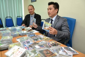 砂贸消局局长斯丹利陈（右）及执法组官员亚历山大展示充公的盗版光碟。