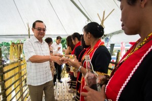 Tan Sri Peter Chin and Dato Sebastian Ting being greeted by longhouse folks