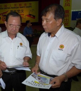 Peter Chin and Sebastian looking at the newsletter