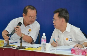 Chin and Senator Datuk Dr. Sim discussing a point