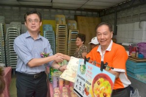 Giving a certificate to a stall owner