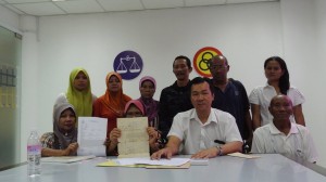 Wilfred Yap with the complainants showing the police report made.