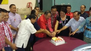 Cutting the anniversary cake.