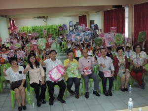 4th from left, Dr Sim distributing the school bags