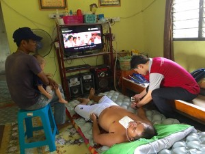 Roslan getting assistance in physio