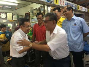Dr. Sim in white shirt at the hawker stall in Hui Sing.
