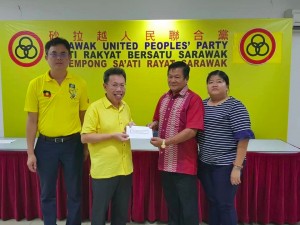 Dr Sim giving away grant