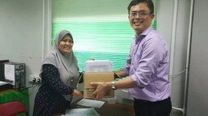 Tan Kai handing over the application to land and survey
